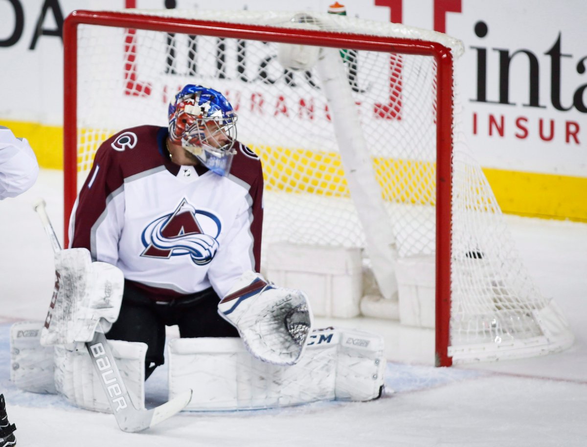 Colorado Avalanche goalie Semyon Varlamov, of Russia, looks back at the net as the Calgary Flames score during second period NHL hockey action in Calgary, Saturday, Feb. 24, 2018.THE CANADIAN PRESS/Jeff McIntosh.