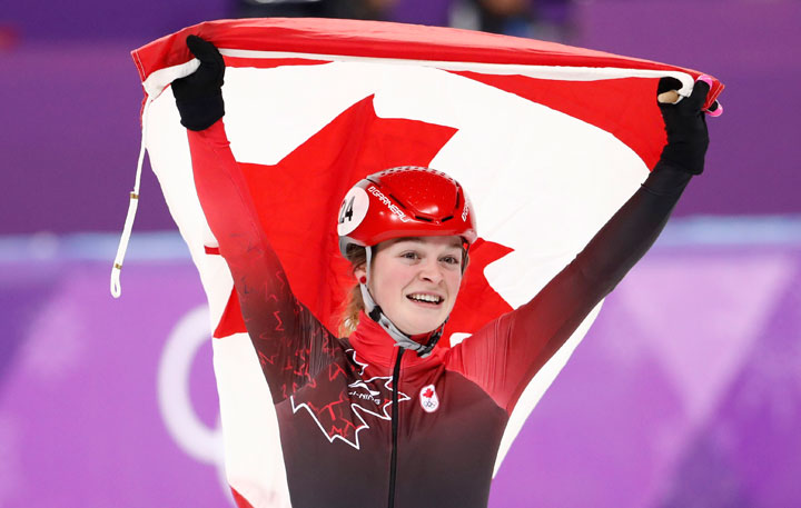 Triple medallist Kim Boutin of Canada celebrates.