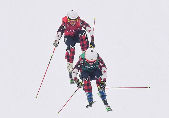 Canadians Kelsey Serwa, top, and Brittany Phelan compete in the women’s ski cross semifinal at the Phoenix Snow Park at the 2018 Winter Olympic Games in Pyeongchang, South Korea, Feb. 23, 2018.