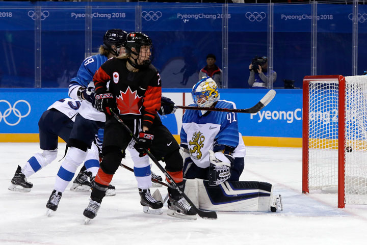 Meghan Agosta (2), of Canada, and Ronja Savolainen, of Finland, watch the puck shot by Melodie Daoust, of Canada, flying into the goal during the second period of the preliminary round of the women's hockey game at the 2018 Winter Olympics in Gangneung, South Korea, Tuesday, Feb. 13, 2018. 