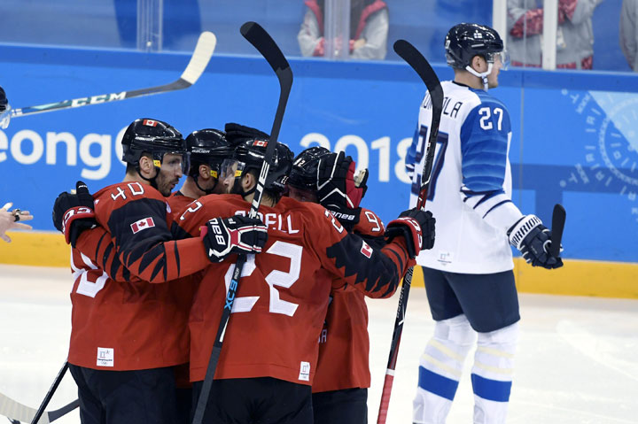 Petri Kontiola (R) of Finland reacts as Canadian players celebrate the team’s first goal during Ice Hockey Men’s Play-offs Quarterfinal match Canada vs Finland at Gangneung Hockey Centre in Gangneung during the Pyeongchang 2018 Winter Olympics on February 21, 2018.