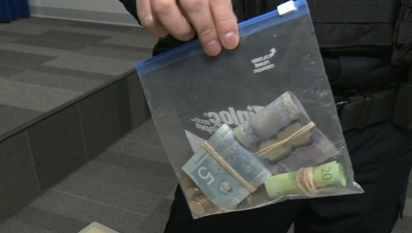 A Ziploc bag full of cash held up by Sgt. Jag Khosa of the CFSEU-BC.