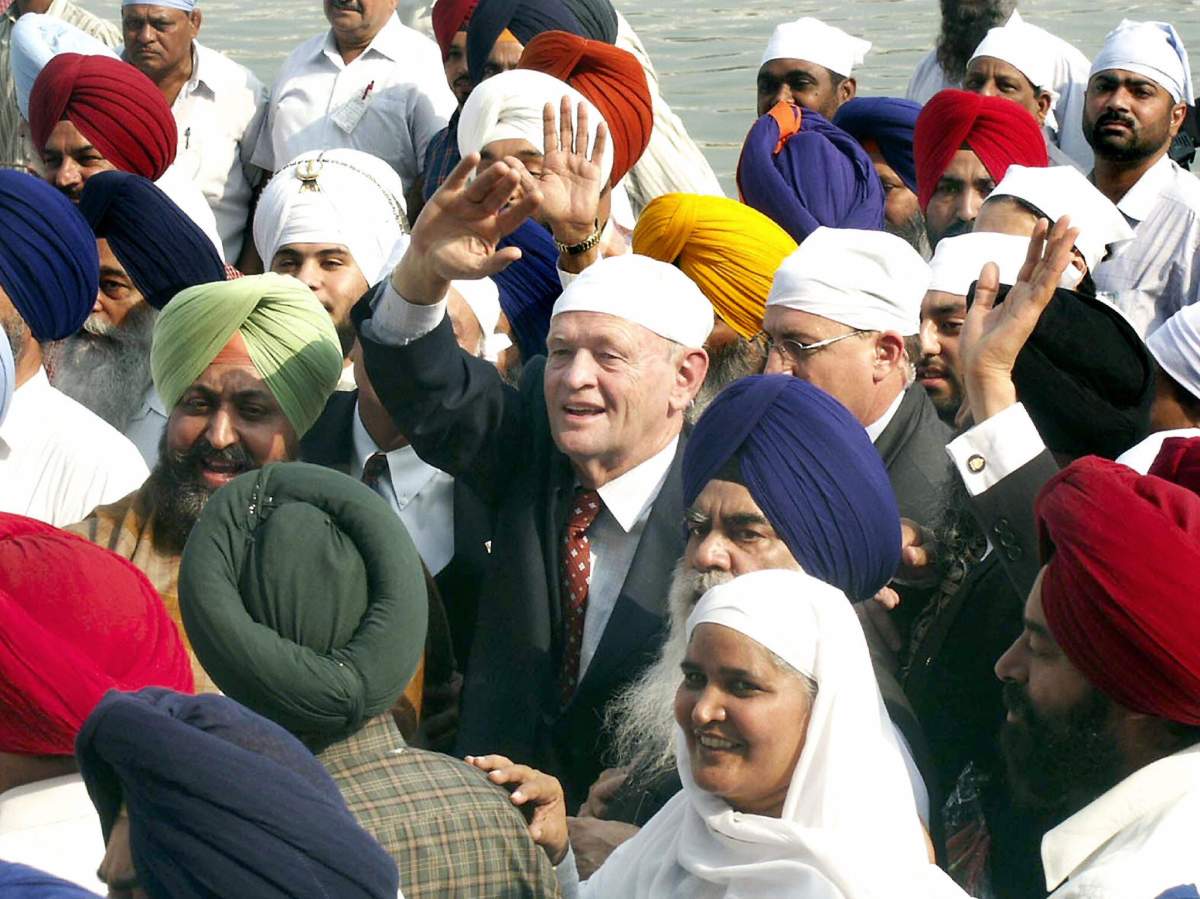 Prime Minister Jean Chretien waves to the crowds during his visit to Sikhism’s holiest shrine, the Golden Temple in Amritsar, Oct. 25, 2003.