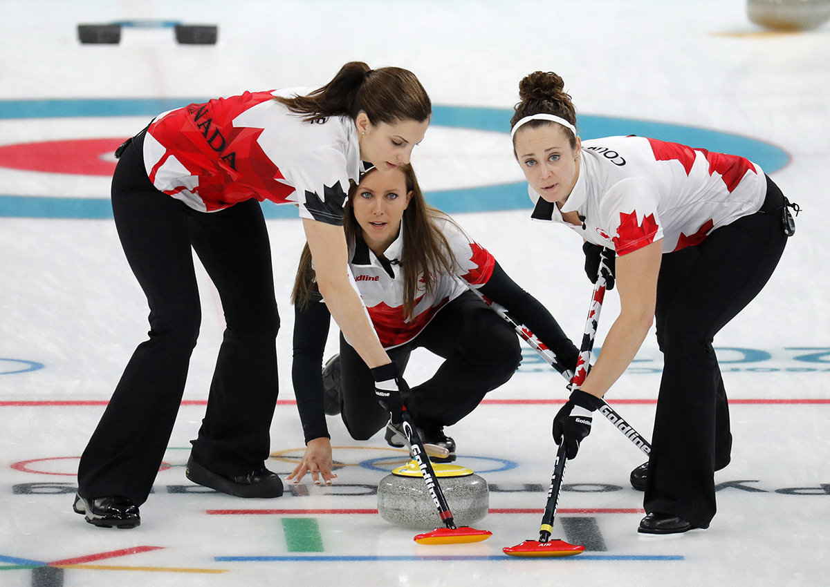 Canada's skip Rachel Homan, center, launches the stone during their women's curling match against Japan at the 2018 Winter Olympics in Gangneung, South Korea, Monday, Feb. 19, 2018.