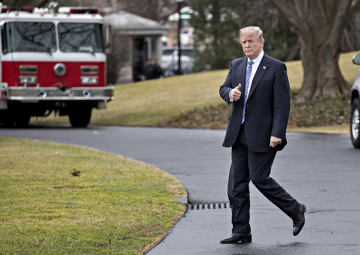 Donald Trump gives a thumbs-up while walking on the South Lawn of the White House toward Marine One in Washington, D.C., U.S., on Friday, Feb. 16, 2018. 
