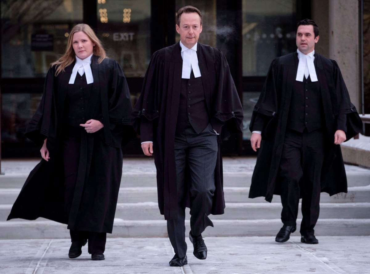 Crown prosecutor Doug Taylor, centre, leaves court after Joshua Frank and Jason Klaus were pronounced guilty by a judge in Red Deer, Alta., Wednesday, Jan. 10, 2018.
