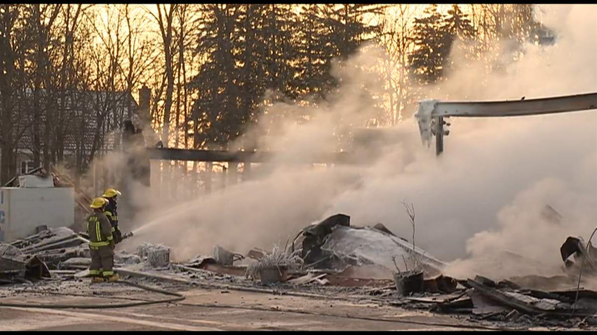 Firefighters douse hot spots early Friday morning.