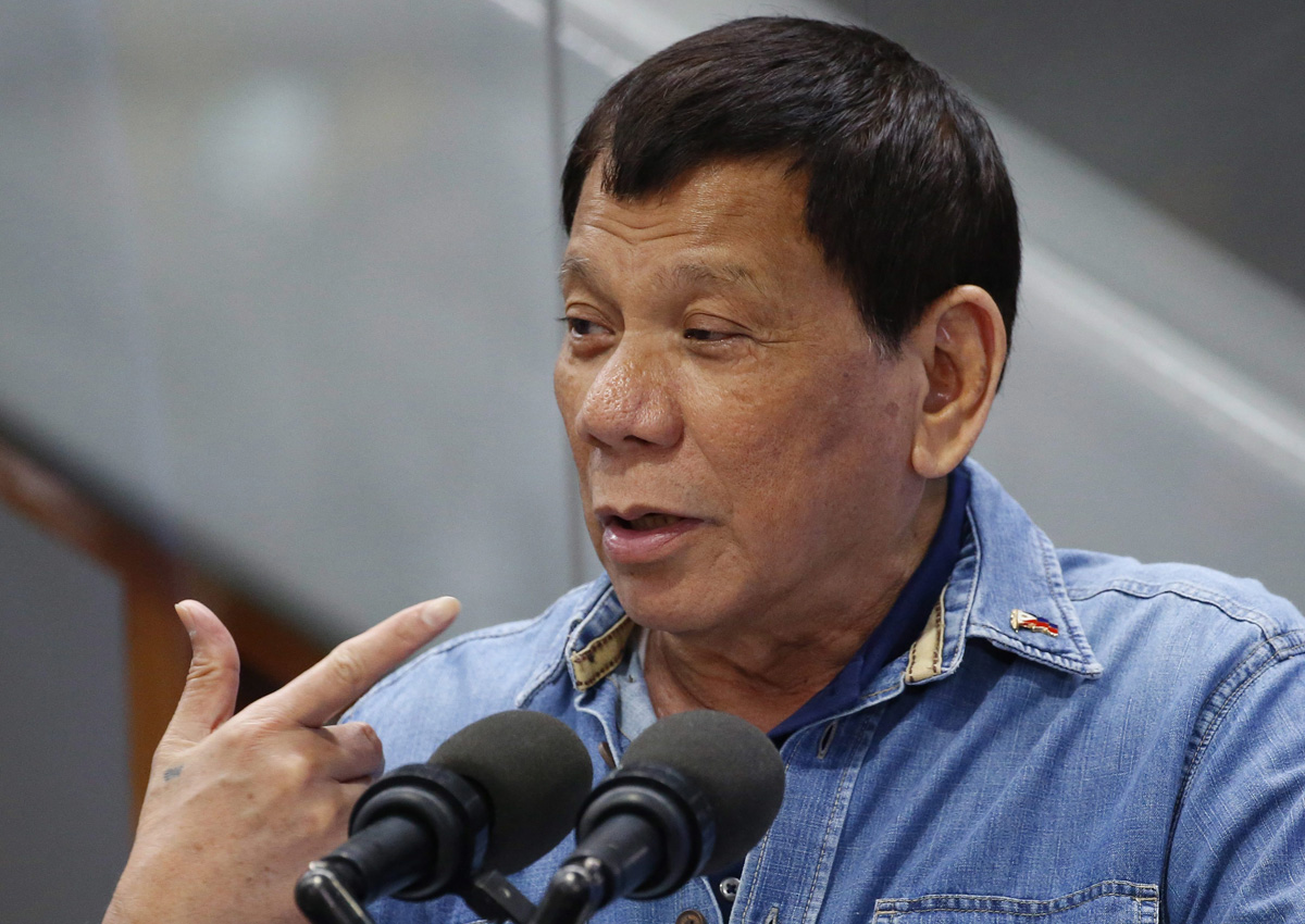 Rodrigo Duterte gestures while addressing Filipino Overseas Workers who were repatriated from Kuwait, Tuesday, Feb. 13, 2018 .