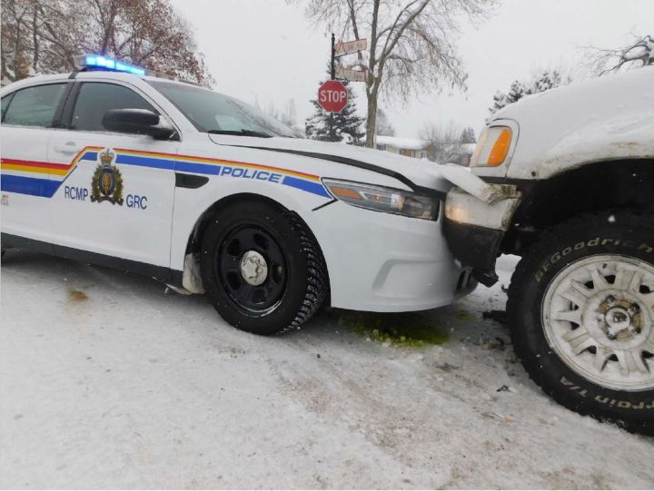 A man is under arrest and an RCMP officer has been released from hospital with minor injuries after being dragged by a pickup truck while trying to arrest the driver in Edson, Alta. on Wednesday.