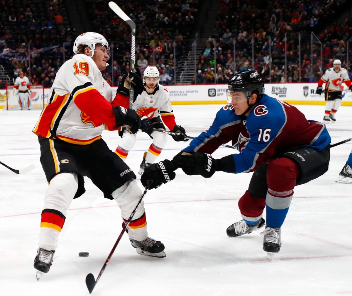 Colorado Avalanche defenseman Nikita Zadorov, right, hits Calgary Flames left wing Matthew Tkachuk as Tkachuk drives to the net with the puck during the second period of an NHL hockey game Wednesday, Feb. 28, 2018, in Denver. (AP Photo/David Zalubowski).