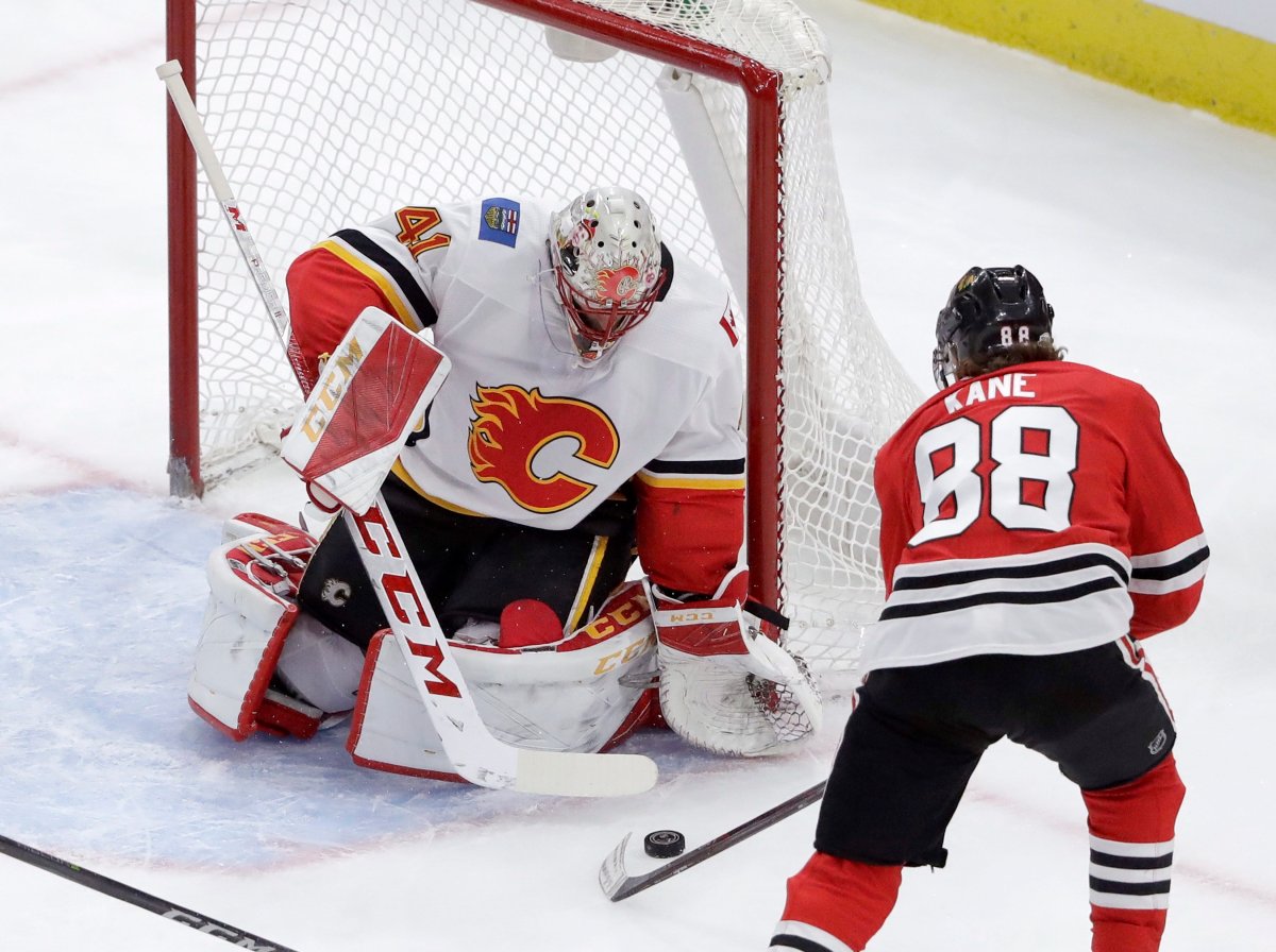 Calgary Flames goaltender Mike Smith makes a save on a shot by Chicago Blackhawks' Patrick Kane during the second period of an NHL hockey game Tuesday, Feb. 6, 2018, in Chicago. (AP Photo/Charles Rex Arbogast).