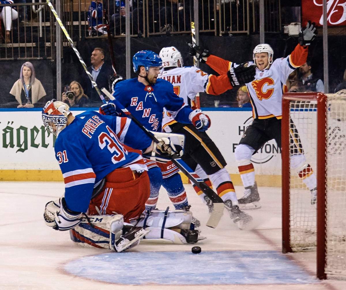 Calgary Flames' Brett Kulak, right celebrates after scoring against the New York Rangers during the first period of an NHL hockey game Friday, Feb. 9, 2018, at Madison Square Garden in New York. (AP Photo/Andres Kudacki).