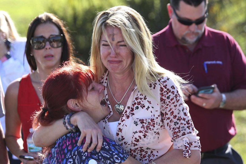 Parents wait for news after a reports of a shooting at Marjory Stoneman Douglas High School in Parkland, Fla., on Wednesday, Feb. 14, 2018. (AP Photo/Joel Auerbach)

.