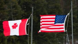 Photo of an American flag and a Canadian flag