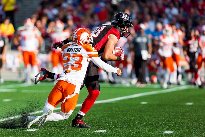 Brad Sinopoli attempts to escape a tackle by defensive back Anthony Gaitor during a Canadian Football League game between the BC Lions and Ottawa RedBlacks on Aug. 26, 2017 at TD Place Stadium in Ottawa.
