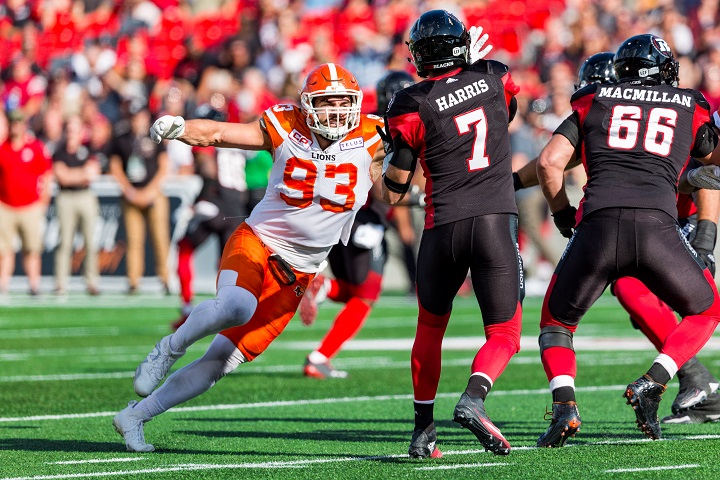 Craig Roh (left) charges towards Ottawa RedBlacks quarterback Trevor Harris during a CFL game on Aug. 26, 2017 at TD Place Stadium in Ottawa.