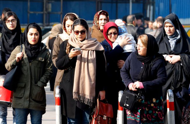 Iranian women wearing hijab walk down a street in the capital Tehran on February 7, 2018.



