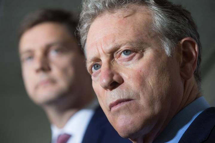 B.C. Environment Minister George Heyman, front, and Attorney General David Eby listen to a question during a news conference about the Kinder Morgan Trans Mountain pipeline expansion project, in Vancouver, B.C., on Thursday August 10, 2017.