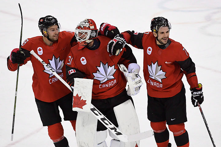Canada goaltender Kevin Poulin, defenceman Marc-Andre Gragnani and forward Rene Bourque celebrate defeating Finland in the Olympic quarterfinal hockey action at the 2018 Olympic Winter Games in Pyeongchang, South Korea on Feb. 21, 2018. 