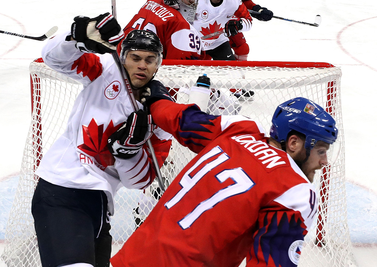 Michal Jordan of the Czech Republic hits Rene Bourque of Canada.