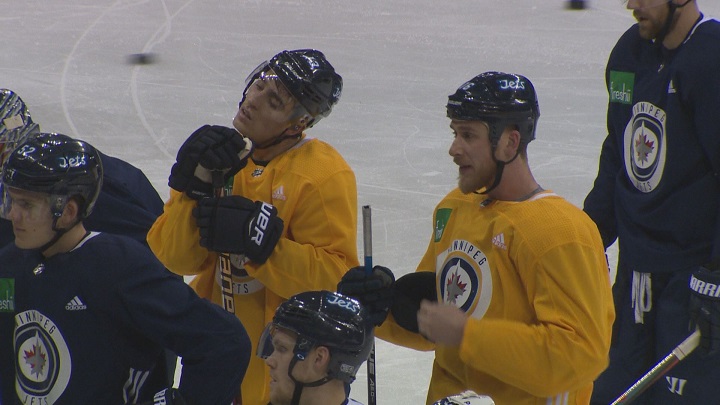 Injured Winnipeg Jets forwards Brandon Tanev and Shawn Matthias listen to instructions during practice on Sunday at Bell MTS Place.