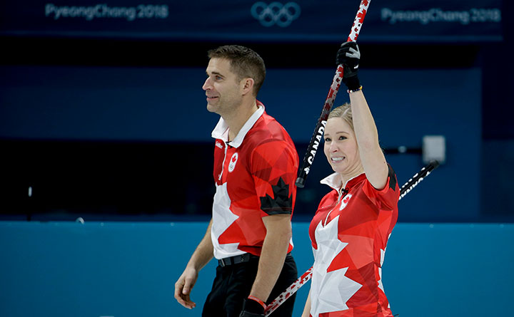 Canada's Kaitlyn Lawes, right, and John Morris celebrate a mixed doubles curling match against South Korea's Jang Hyeji and Lee Kijeong at the 2018 Winter Olympics in Gangneung, South Korea, Sunday, Feb. 11, 2018. AP Photo/Natacha Pisarenko.