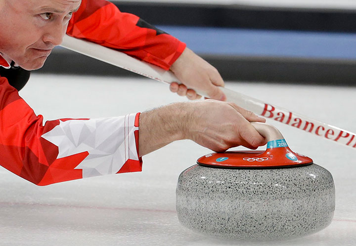 Canada's skip Kevin Koe throws a rock during a men's curling match against Italy at the 2018 Winter Olympics in Gangneung, South Korea, Wednesday, Feb. 14, 2018. 
