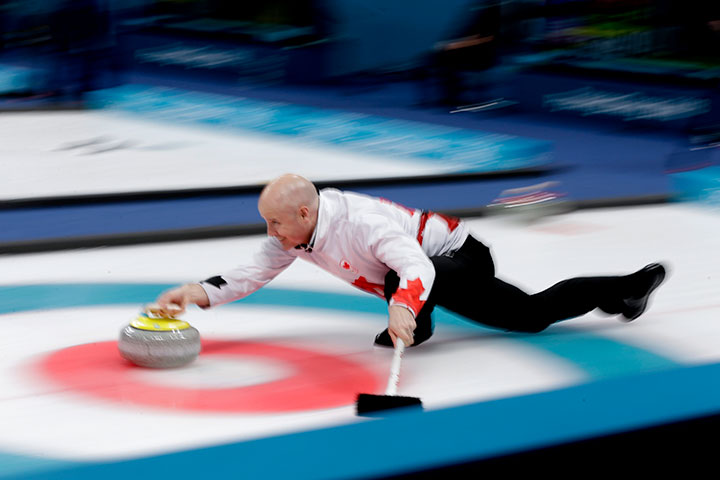 Canada’s skip Kevin Koe throws a stone during a men’s curling match against Denmark at the 2018 Winter Olympics in Gangneung, South Korea, Feb. 21, 2018.