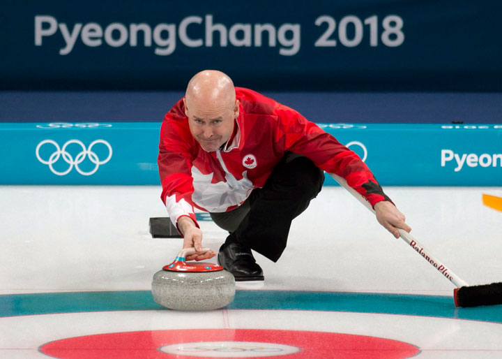 Kevin Koe throws a stone during his draw one match against Italy on Feb.14, 2018.