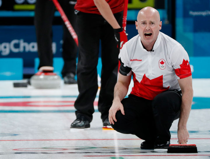 Skip Kevin Koe of Canada shouts at teammates. 