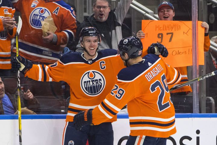 Edmonton Oilers' Connor McDavid (97) and Leon Draisaitl (29) celebrate a goal against the Tampa Bay Lightning during second period NHL action in Edmonton, Alta., on Monday February 5, 2018. 