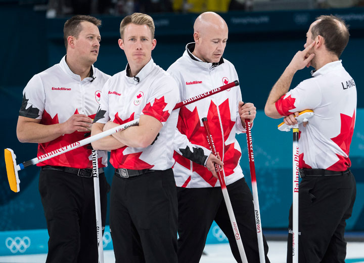Canadians Kevin Koe, centre, with teammates Ben Hebert, left, Marc Kennedy, second left, and Brent Laing, right, look on while playing against Switzerland during men’s bronze medal curling finals at the 2018 Olympic Winter Games in Gangneung, South Korea on Friday, February 23, 2018.