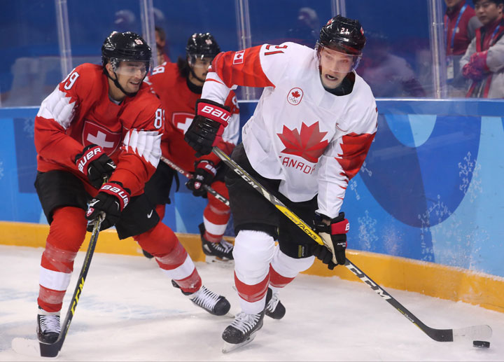 Cody Almond (L) of Switzerland in action against Mason Raymond of Canada during the men's Ice Hockey preliminary round match between Switzerland and Canada at the Kwandong Hockey Centre in Gangneung during the PyeongChang Winter Olympic Games 2018, South Korea, 15 February 2018. 