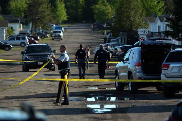 FILE - RCMP investigators work at the home of shooting suspect Justin Bourque in Moncton, N.B. on Sunday, June 8, 2014.