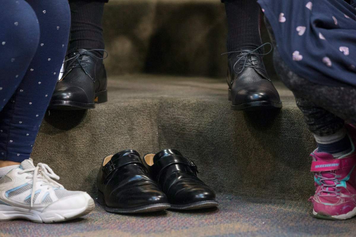 Federal Finance Minister Bill Morneau wears a new pair of shoes from Edmonton\’s Poppy Barley Shoe manufacturer as he sits wth students from Toronto\’s Rose Avenue Junior Public School during a pre-budget photo opportunity in Toronto, on Friday February 23, 2018.