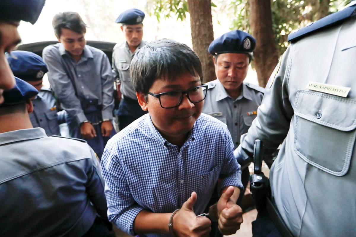 Detained Reuters journalist Wa Lone and Kyaw Soe Oo are escorted by police while arriving for a court hearing in Yangon, Myanmar February 1, 2018. REUTERS/Jorge Silva