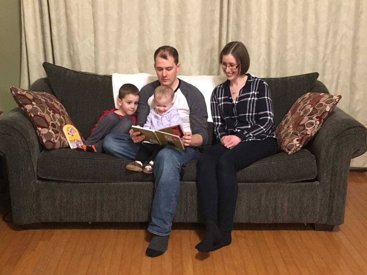 Nathan and Sarah Koops reading to their children at home in Fort McMurray.