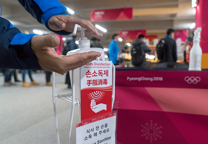 A man sanitizes his hands at the entrance to the media cafeteria, Wednesday, February 7, 2018 in Gangneung, South Korea. 