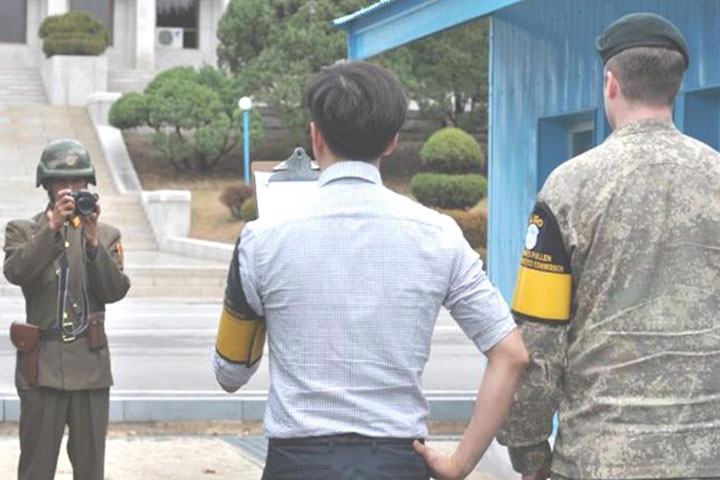 North Koreans filming a message at the DMZ.