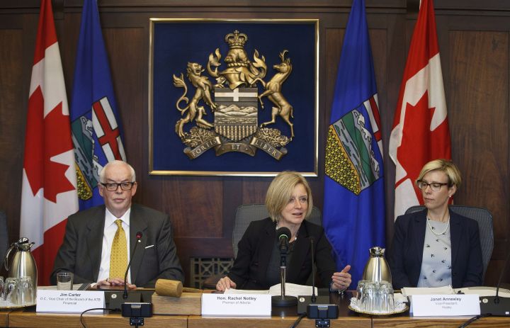 Vice Chair of the Board of ATB Financial Jim Carter, left, and Vice President of Husky Janet Annesley, right, listen as Alberta Premier Rachel Notley makes remarks before the first meeting of the Market Access Task Force, convened to respond to B.C. in the fight over the Trans Mountain oil pipeline, in Edmonton Alta, on Wednesday February 14, 2018. 