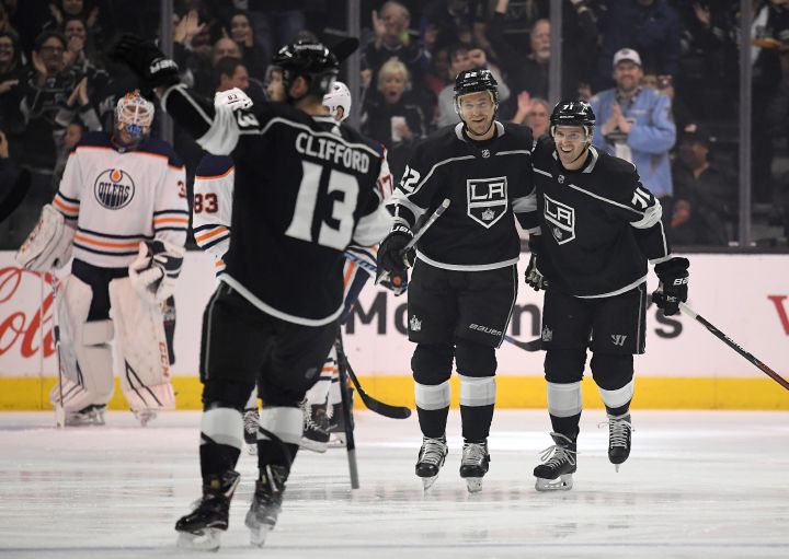 Los Angeles Kings left wing Kyle Clifford, second from left, celebrates his goal along with center Trevor Lewis, second from right, and center Torrey Mitchell as Edmonton Oilers goaltender Cam Talbot watches during the first period of an NHL hockey game, Wednesday, Feb. 7, 2018, in Los Angeles. 