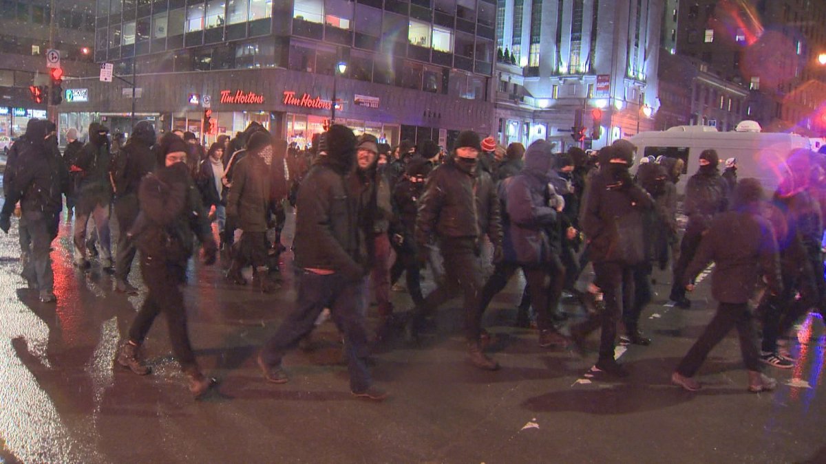 A group of about 50 people gathered in Montreal to protest against police, Thursday, Feb. 1, 2018.