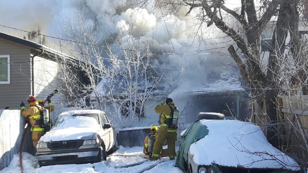 Fire fighters attempt to extinguish a house fire on the 1500 block of Rae Street. 