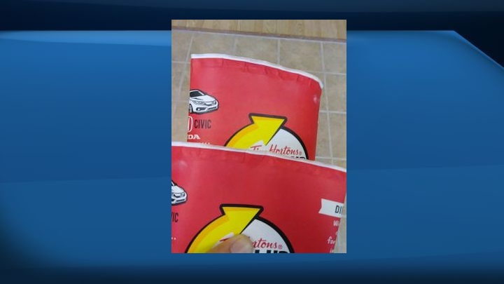 Adam Peddle says he has a growing collection of Tim Hortons Roll up the Rim cups, but they're not winners â€” there's no message at all under the rim as shown in this handout image.
