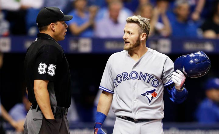 Toronto Blue Jays' Josh Donaldson talks to home plate umpire Stu Scheurwater during a baseball game on April 6, 2017, in Florida.
