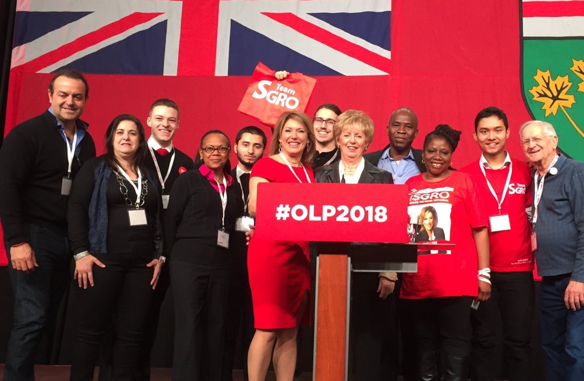 Ontario Liberal candidate Deanna Sgro, at podium in red dress, beside her mother, Liberal MP Judy Sgro.