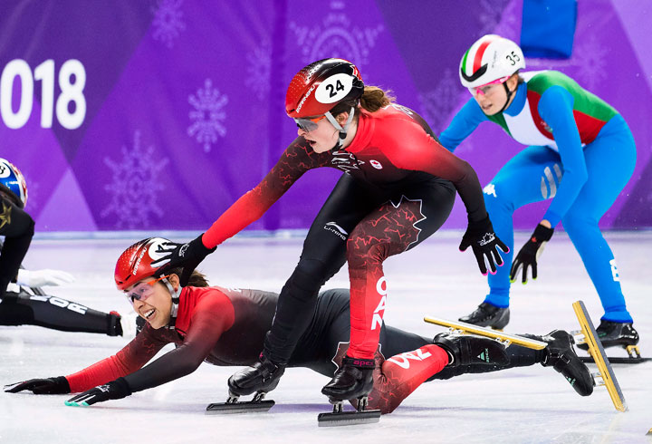 Valerie Maltais, of Canada, falls as teammate Kim Boutin tries to help her as they compete in the women's 3,000m short track speed skating relay during the 2018 Olympic Winter Games in Gangneung, South Korea on Tuesday, February 20, 2018.