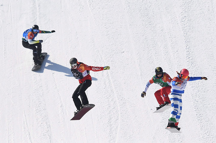 Canada's Tess Critchlow of Kelowna, B.C. (second from left) competes in the women's snowboard cross small final at the Phoenix Snow Park at the 2018 Winter Olympic Games in Pyeongchang, South Korea, Friday, Feb. 16, 2018. 