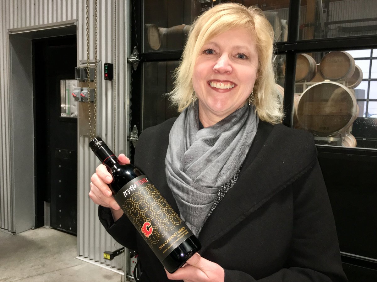 TIME winery's Christa-Lee McWatters-Bond holds a bottle of wine produced for the Calgary Flames. 