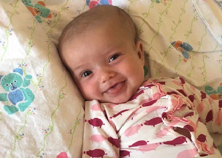 Baby Rowan Jones smiling as she recovers in a Florida hospital after family says she hit her head during a vacation.